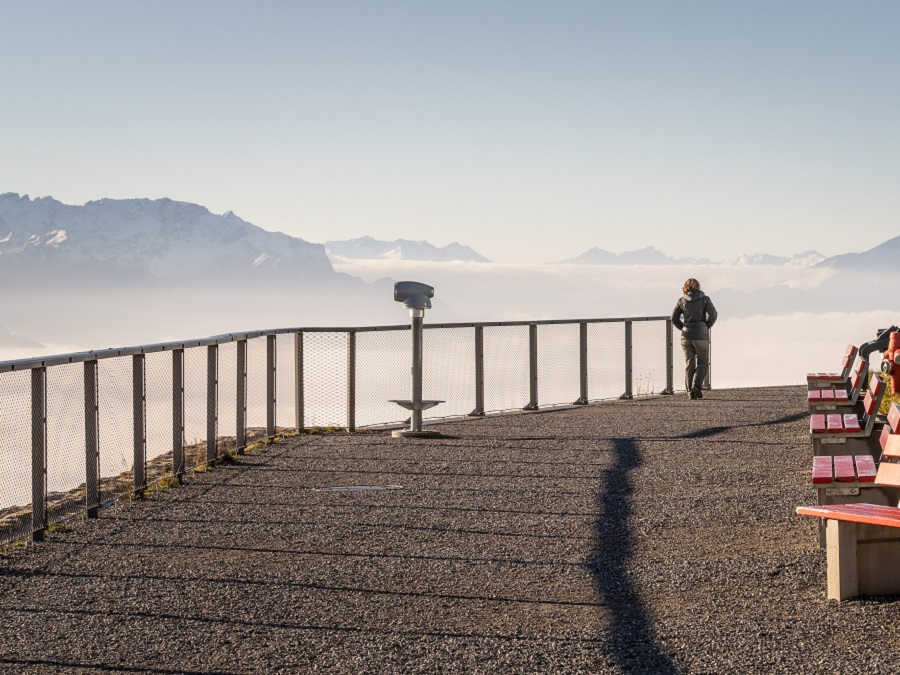 Frau läuft auf dem Europa-Rundweg und blick Richtung Rheintal auf ein Nebelmeer